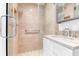 A bathroom featuring a glass walk-in shower with decorative tile and a sink vanity with marble countertop at 1 King # 702, Charleston, SC 29401