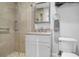 A bright bathroom featuring a glass walk-in shower with decorative tile, and a sink vanity with stone countertop at 1 King # 702, Charleston, SC 29401