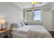 Bright bedroom featuring large windows and ocean view, neutral walls, ceiling fan, and a cozy bed with plush linens at 1 King # 702, Charleston, SC 29401