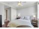 Bedroom with a dark-stained wood floor, neutral walls, ceiling fan, and a cozy bed with plush bedding at 1 King # 702, Charleston, SC 29401