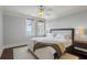 Bedroom with neutral decor, ceiling fan, and windows offering a view of the water at 1 King # 702, Charleston, SC 29401