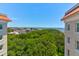 Beautiful city view overlooking lush treetops, historic rooftops and blue ocean waters under a bright sky at 1 King # 702, Charleston, SC 29401
