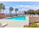 Community pool area with palm trees, lounge chairs, ocean views, and meticulously landscaped with flowers and shrubbery at 1 King # 702, Charleston, SC 29401