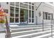 Elegant entryway with white stone steps, glass doors, and classic architectural details at 1 King # 702, Charleston, SC 29401