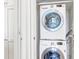 A laundry closet featuring an LG washer and dryer, stacked to maximize space and a white cabinet at 1 King # 702, Charleston, SC 29401