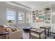 Bright living room with custom built-ins and beautiful ocean views from the oversized picture windows at 1 King # 702, Charleston, SC 29401