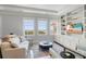 Bright living room with built-in shelves, modern furniture, and hardwood floors at 1 King # 702, Charleston, SC 29401