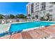 Inviting outdoor pool area with lounge chairs, umbrellas, and a view of the surrounding landscape at 1 King # 702, Charleston, SC 29401