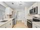 Modern kitchen with stainless steel appliances, white cabinets, and updated fixtures at 1001 Waterwood Dr, Goose Creek, SC 29445