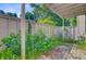 Exterior shot of a patio area with lush greenery and a light-colored fence at 1001 Waterwood Dr, Goose Creek, SC 29445