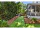 Backyard with screened porch, artificial grass, landscaping, and a metal stock tank pool at 1033 Mathis Ferry Rd, Mount Pleasant, SC 29464