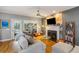Cozy living room showcasing a fireplace, plush seating, and views of the landscaped backyard at 1033 Mathis Ferry Rd, Mount Pleasant, SC 29464