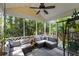 Relaxing screened porch with comfortable seating, ceiling fan, and lush greenery at 1033 Mathis Ferry Rd, Mount Pleasant, SC 29464