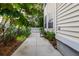 Side yard of house with yellow siding, a garden, and a white picket gate at 1033 Mathis Ferry Rd, Mount Pleasant, SC 29464