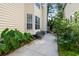 A quaint side yard features a small bench and lush landscaping, perfect for relaxation at 1033 Mathis Ferry Rd, Mount Pleasant, SC 29464