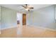 Spacious bedroom with hardwood floors and a ceiling fan, leading to a bathroom at 105 Greendale Ct, Summerville, SC 29485