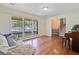 Sunlit living room with hardwood flooring, large windows, and comfortable sofa at 105 Greendale Ct, Summerville, SC 29485