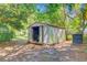 Backyard shed with an open door, adjacent to an air conditioning unit and shady trees at 105 Greendale Ct, Summerville, SC 29485