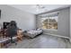 Cozy bedroom features a ceiling fan, a bright window, and modern gray flooring at 106 Maypop Dr, Goose Creek, SC 29445