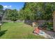 Expansive backyard featuring green lawn, outdoor seating area, and garden beds at 106 Sioux Ct, Summerville, SC 29483