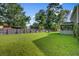 Expansive backyard with lush green grass, privacy fence, and outdoor seating area at 106 Sioux Ct, Summerville, SC 29483
