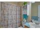 Functional bathroom with a shower featuring a floral curtain and built-in shelving at 106 Sioux Ct, Summerville, SC 29483