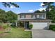 Charming two-story home with a manicured lawn, green shutters, and a welcoming front porch at 106 Sioux Ct, Summerville, SC 29483