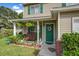 Inviting front porch featuring a wooden bench, decorative plants, and a green front door with a wreath at 106 Sioux Ct, Summerville, SC 29483