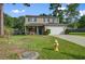 Well-maintained two-story home with a green lawn and mature trees in a quiet neighborhood at 106 Sioux Ct, Summerville, SC 29483
