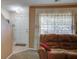 Comfortable living room with tile floors at the entryway, carpet, and a white front door at 106 Sioux Ct, Summerville, SC 29483