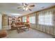 Cozy living room featuring a ceiling fan, plush sofa, and seamless flow into the adjacent kitchen area at 106 Sioux Ct, Summerville, SC 29483