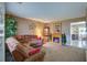 Cozy living room featuring a fireplace, comfortable seating, and an open view into the kitchen at 106 Sioux Ct, Summerville, SC 29483