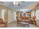 Comfortable living room showcasing a ceiling fan, a plush sofa, and an open view into the kitchen at 106 Sioux Ct, Summerville, SC 29483
