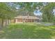 Expansive backyard with a brick home, patio, and a gravel fire pit for relaxing evenings at 110 Clubhouse Rd, Summerville, SC 29483