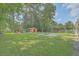 Extensive backyard with a playground, storage shed, fire pit, and a lush lawn for outdoor fun at 110 Clubhouse Rd, Summerville, SC 29483