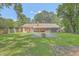 Large brick home with a screened in porch and spacious backyard with a patio and fire pit area at 110 Clubhouse Rd, Summerville, SC 29483