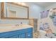 Charming bathroom featuring a blue vanity and floral shower curtain at 110 Clubhouse Rd, Summerville, SC 29483