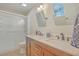 Bathroom with a double sink vanity, framed mirrors, and walk-in shower at 110 Clubhouse Rd, Summerville, SC 29483