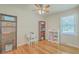 Bright bedroom with hardwood floors, storage shelves, and a window with natural light at 110 Clubhouse Rd, Summerville, SC 29483