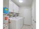 Bright laundry room with white cabinets, tile floor, washer, dryer and water heater at 110 Clubhouse Rd, Summerville, SC 29483
