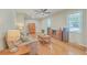 Comfortable living room with hardwood floors, ceiling fan, and abundant natural light at 110 Clubhouse Rd, Summerville, SC 29483