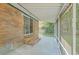 Covered patio with brick accents and a screened-in view of the backyard at 110 Clubhouse Rd, Summerville, SC 29483