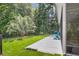 Expansive backyard with lush green lawn, mature trees, and an inviting patio area at 1115 Old Field Dr, Summerville, SC 29483