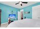 Bright bedroom with beach decor, TV, and a ceiling fan for a cool and relaxing space at 1115 Old Field Dr, Summerville, SC 29483