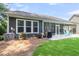 Exterior of the home featuring a screened in porch, outdoor patio and well maintained landscaping at 1115 Old Field Dr, Summerville, SC 29483