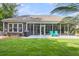 View of back exterior of the home showcasing the outdoor living spaces and manicured lawn at 1115 Old Field Dr, Summerville, SC 29483