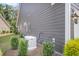 Side exterior of home featuring home generator with manicured landscaping at 1115 Old Field Dr, Summerville, SC 29483