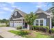 Attractive home exterior with a two-car garage, an American flag, and landscaped front yard at 1115 Old Field Dr, Summerville, SC 29483