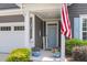 Cozy front porch with an American flag, colorful potted flowers, and a welcoming entrance at 1115 Old Field Dr, Summerville, SC 29483