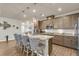 Stylish kitchen with an island, bar stools, modern pendant lights, and warm wood cabinetry at 1115 Old Field Dr, Summerville, SC 29483
